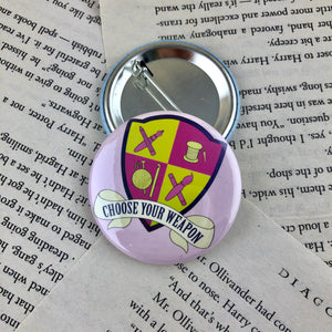 purple and lime green creative crest button reading "choose your weapon"